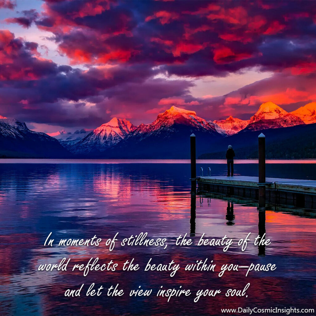 A figure stands on the end of a pier jutting out into a lake, taking in the brilliant red and purple hues of sunset over snow-capped mountains, the entire scene reflected in the waters of the lake. The text reads, "In moments of stillness, the beauty of the world reflects the beauty within you—pause and let the view inspire your soul."